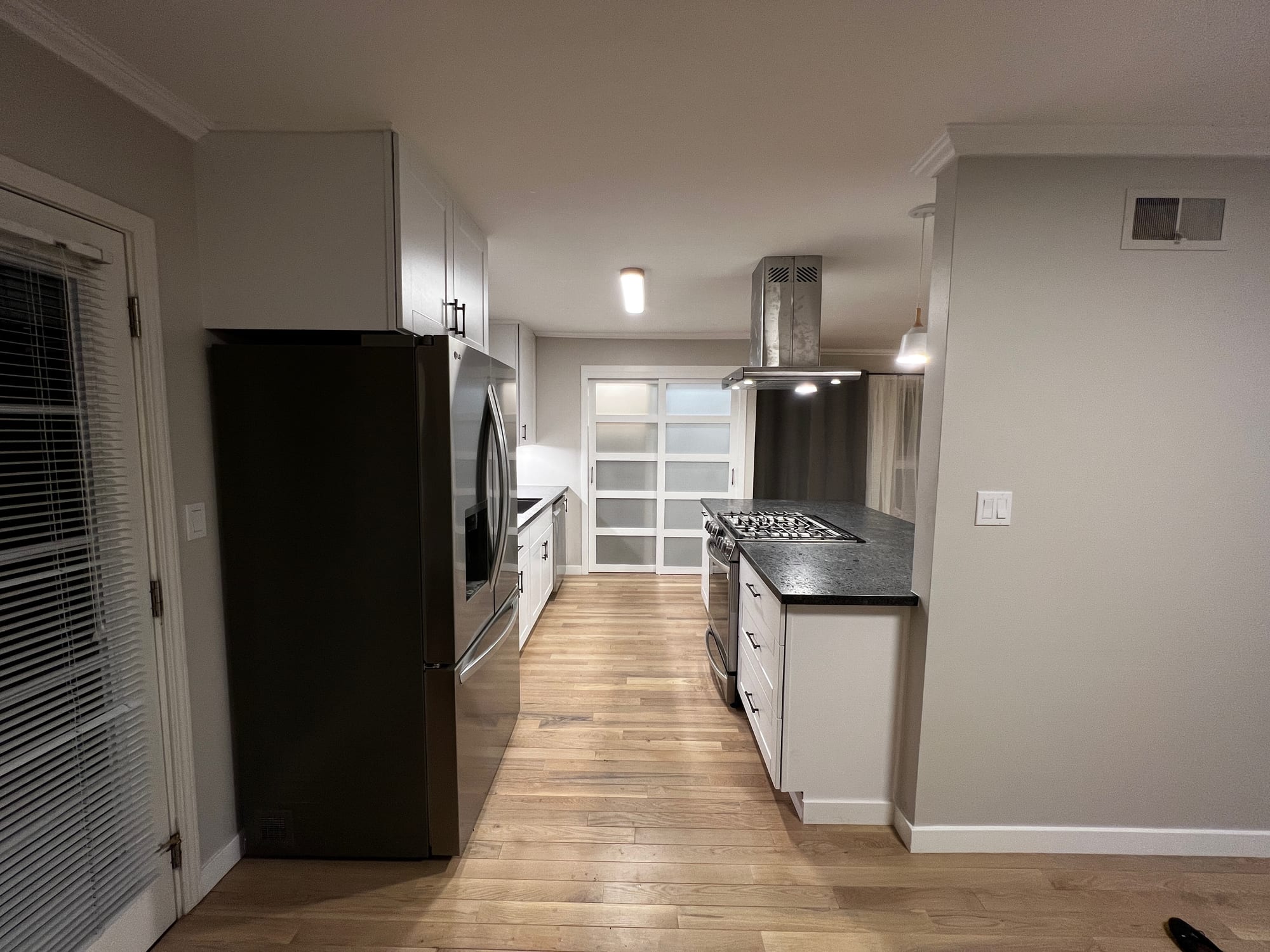 Finished galley kitchen with black countertops
