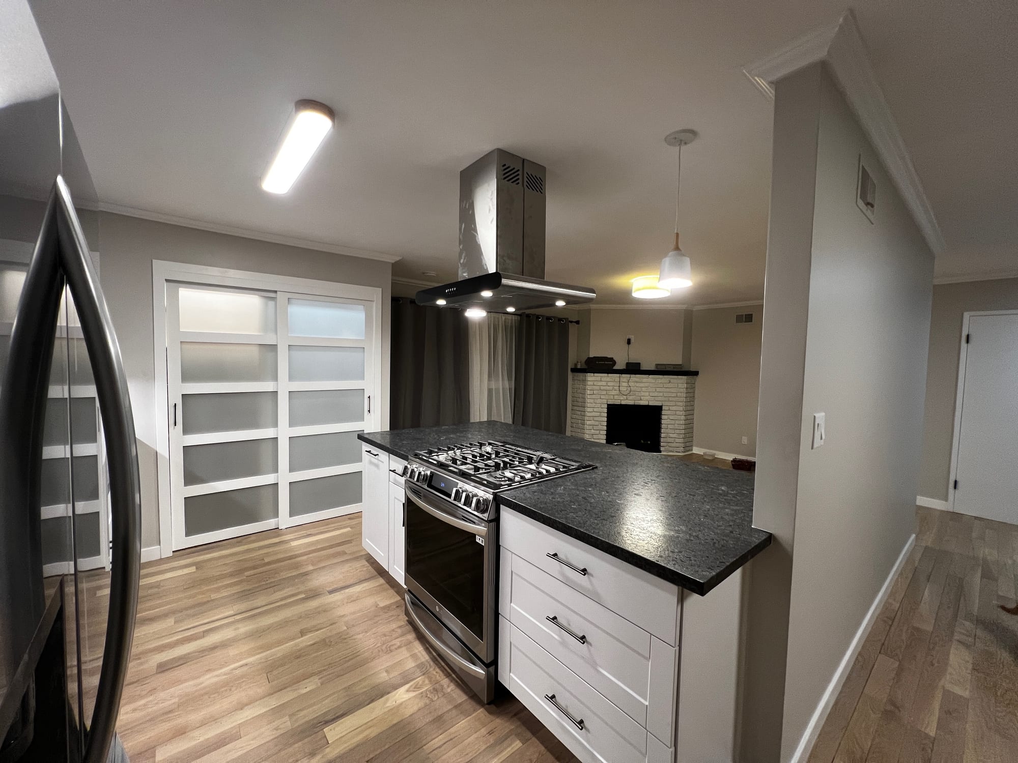 Kitchen island with gas range and hood