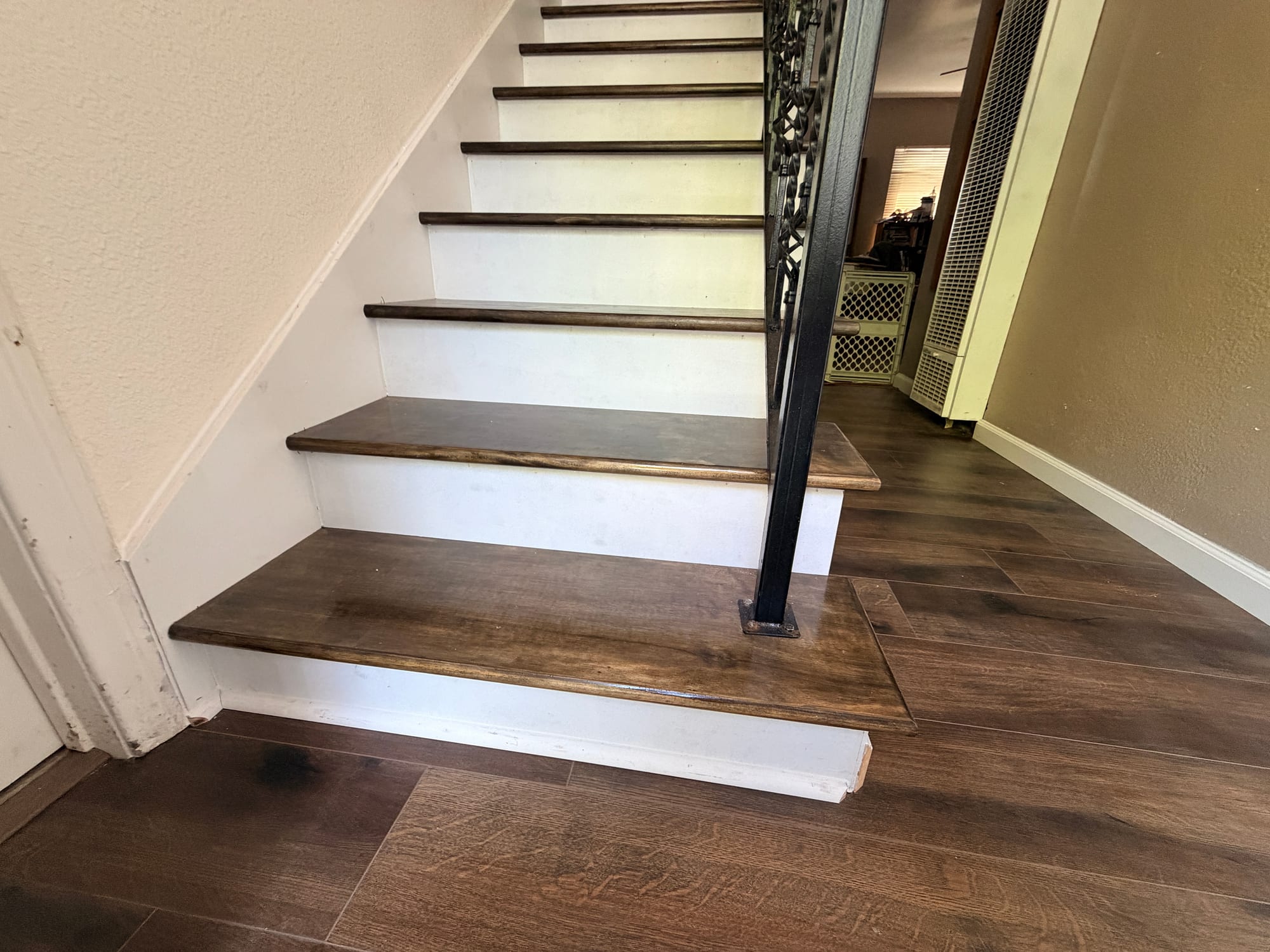 Custom stained staircase with iron railing
